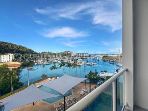 a balcony with a view of a marina at Beachside 17 in Nelly Bay