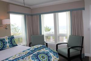 Postel nebo postele na pokoji v ubytování Alouette Sunrise Suites