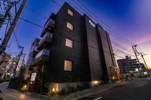 a building on a city street at night at ReLA 柏駅北 in Kashiwa