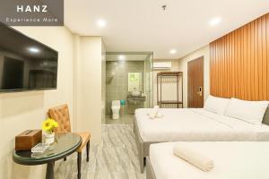 a hotel room with two beds and a glass table at S79 Hotel T68 in Ho Chi Minh City