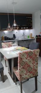 a kitchen with a table and chairs in a kitchen at CASACOMPART Quarto individual in Salvador +11 photos