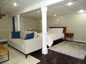 a large bedroom with a bed and a couch at Comfortable Renovated 3 Bed Apartment in Framingham