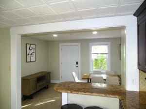 a living room with a table and white chairs at Comfortable Renovated 3 Bed Apartment in Framingham