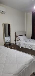 Ένα ή περισσότερα κρεβάτια σε δωμάτιο στο Jannat Madinaty +11 φωτογραφίες