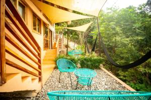 a patio with two chairs and a hose at 2 Room Loft, Kitchen, Garden in Mazunte