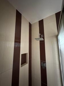 a bathroom with a shower with brown and white stripes at Casa Lujosa, Catemaco, Ubicación Céntrica in Catemaco +8 photos
