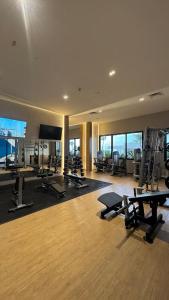 a gym with several treadmills and machines in a building at Progreso Luxury Oceanfront Condo at Yucalpetén Resort Marina in Progreso
