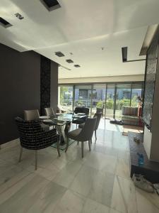a dining room with a glass table and chairs at Luxury Stay in Prestigia Golf City in Bouskoura +24 photos