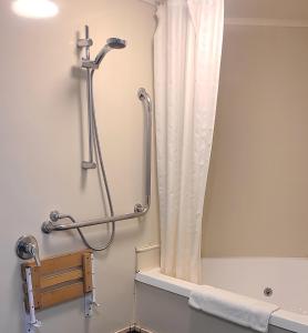 a shower in a bathroom with a shower curtain at BK's Fountain Court Motel in Napier