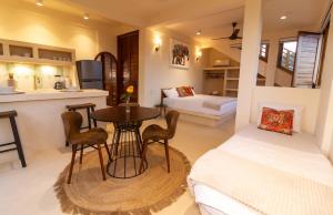 a bedroom with a bed and a table in a room at Ocean Views Amazing Rooftop in Mazunte