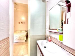 a bathroom with a sink and a mirror and a bed at Ding Doong 2nd Homes in Hanoi +86 photos