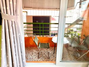 a room with a window with a chair and a table at Ding Doong 2nd Homes in Hanoi