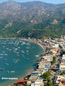 an aerial view of a beach with boats in the water at Casa Blanca Puerto Marqués 10 in Acapulco