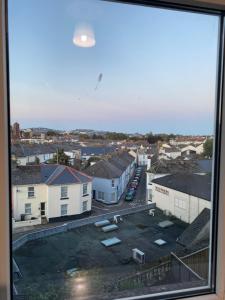 a view of a city from a window at Central studio in Paignton