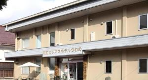 a building with a sign on the front of it at Business Hotel Tsuwano in Tsuwano