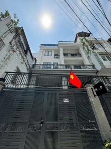 a building with a flag in front of it at Be Staycation Sai Gon in Ho Chi Minh City