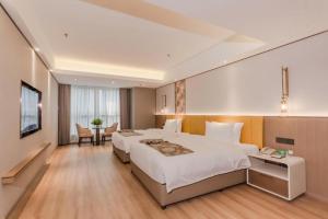a hotel room with two beds and a television at Chengdu Antai Century Hotel in Chengdu +199 photos