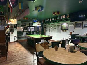 a restaurant with tables and a pool table at duck inn manila in Manila