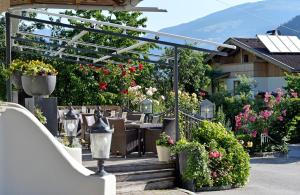 a patio with flowers and plants in a house at Ferienhotel Neuwirt in Hippach