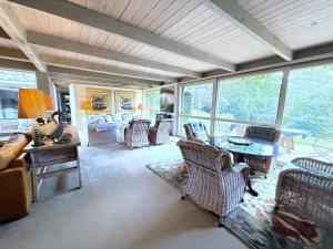 a living room with chairs and a table and a couch at Foxwood - Romantic French Style Country Retreat in Foxground