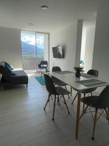 a living room with a table and chairs with a view at Apartamento Nuevo Hermosa Vista in Ibagué