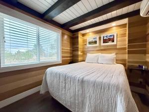 a bedroom with a bed in a room with a window at Escalante Escapes Desert Willow- Loft Escape in Escalante