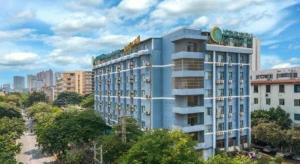 a tall blue building with a sign on top of it at City Comfort Inn Nanning Dancun Road in Nanning