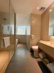une salle de bain avec toilettes, lavabo et douche dans l'établissement City Comfort Inn Nantong Qidong Renmin Zhong Road Xingfudao, à Huilongzhen