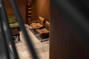 a room with two chairs and a table at Namóra by Lumina in Guadalajara