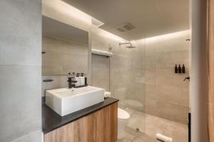a bathroom with a sink and a toilet at Namóra by Lumina in Guadalajara