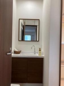 a bathroom with a sink and a mirror at Wine Inn Tomu - Vacation STAY 42199v in Katsunuma