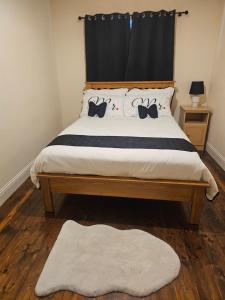 a bedroom with a bed with two cats on it at Listowel Town in Listowel