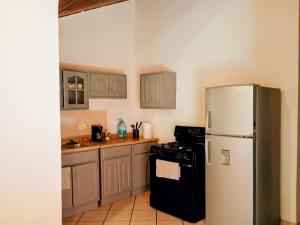 a kitchen with a refrigerator and a stove at Casa a una cuadra de la playa in Ensenada +6 photos