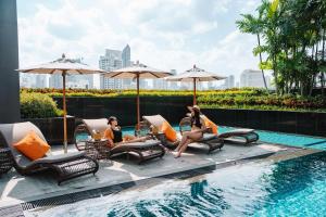 a group of people sitting next to a swimming pool at Hotel JAL City Bangkok in Bangkok +82 photos