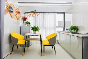 a kitchen with yellow chairs and a table at Super 8 Hotel Chengdu Kuan Zhai Zane Huapaifang in Chengdu