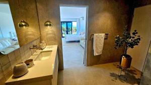 a bathroom with a sink and a mirror at Cielo Flaxton, Newly Renovated Luxury Accommodation with Ocean and Iconic Views in Flaxton