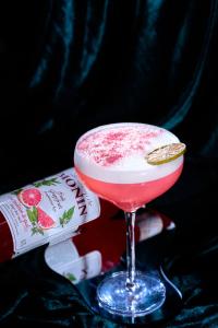 a drink in a martini glass next to a bottle at Kecho Legacy Hotel Hanoi & Spa in Hanoi +126 photos
