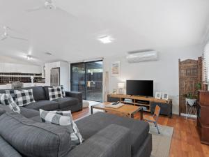 a living room with two couches and a television at Bungalow at Bridgewater Bay by Ready Set Stay in Blairgowrie