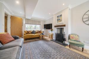 a living room with a couch and a fireplace at Orchard House Docking in Docking