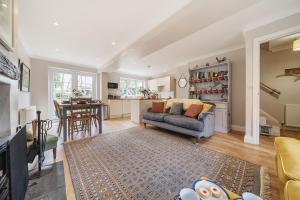 a living room with a couch and a kitchen at Orchard House Docking in Docking