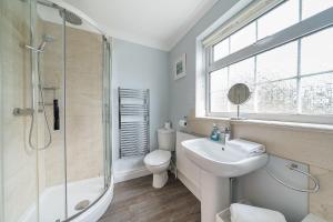 a bathroom with a sink and a shower and a toilet at Orchard House Docking in Docking +20 photos