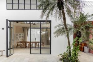 an open door to a dining room with a table at BI Design House Canggu in Canggu