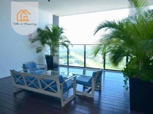 a patio with a table and chairs and a large window at KANVAS SOHO Cyberjaya Haven - 1BR - WiFi in Cyberjaya