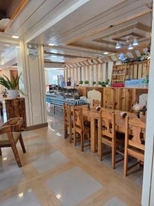 a dining room with wooden tables and chairs at Quarrybay Hometel Sagada in Sagada