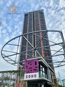 a tall building with a sign in front of it at Cozy Apartment for Two - KANVAS SOHO Cyberjaya in Cyberjaya
