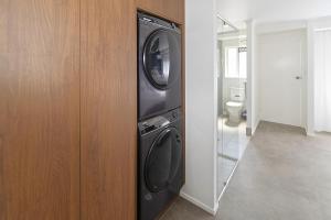 a washer and dryer in a room with a mirror at Studio Three 