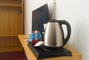 a coffee maker sitting on top of a table at Seaside Hotel in Gili Trawangan