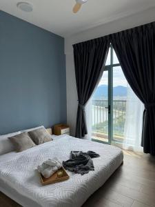 a bedroom with a bed and a large window at Bay Suites Likas - 沙巴民宿 - 3 Min to KK City - Sea View in Kota Kinabalu
