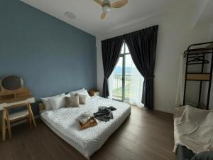 a bedroom with a bed and a large window at Bay Suites Likas - 沙巴民宿 - 3 Min to KK City - Sea View in Kota Kinabalu +13 photos