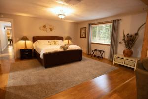 a bedroom with a large bed and a window at 5 acres, Pool, Hot-tub, Zipline, Firepit, Arcade, BBQ, Shuffleboard in Deer Park +102 photos